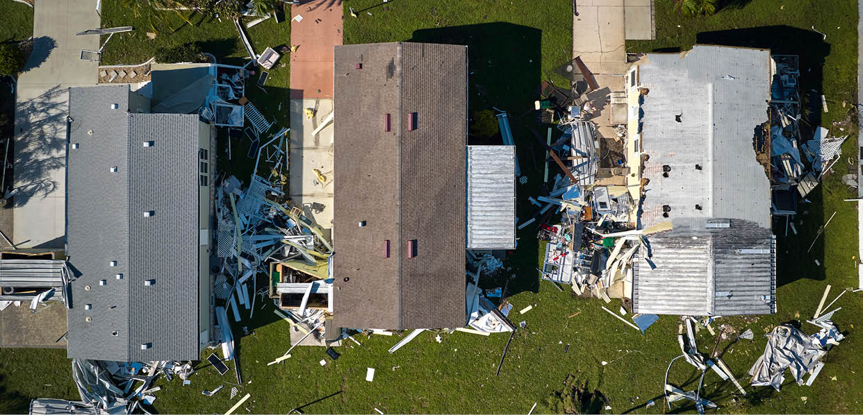 Hurricane Ian destroyed homes in Florida residential area. Natural disaster and its consequences.
