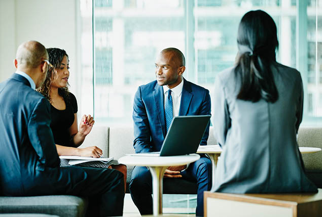 Businesswoman leading project discussion during meeting with colleagues in office